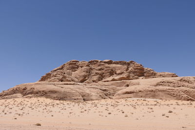 Rock formations in wadi rum  against clear blue sky
