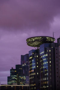 Low angle view of modern buildings against sky at night