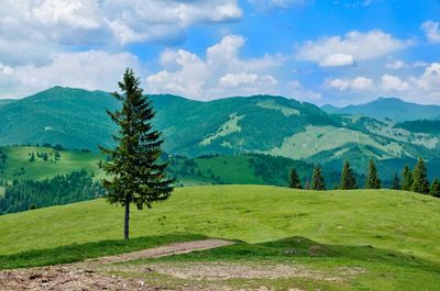 Scenic view of mountains against cloudy sky