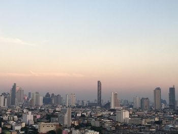 Cityscape against sky during sunset