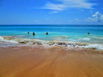 Scenic view of beach against blue sky