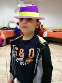 Portrait of boy wearing hat standing outdoors