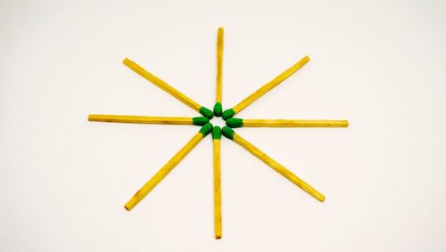 Yellow umbrella against white background