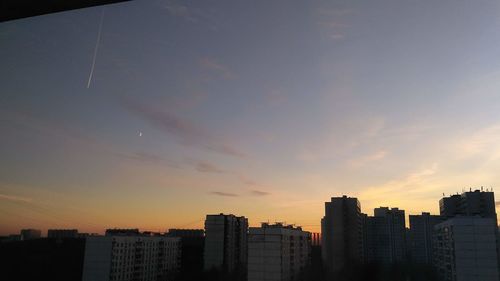 Silhouette buildings against sky during sunset