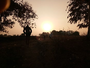 Silhouette of men at sunset