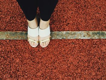 Low section of woman standing on tiled floor