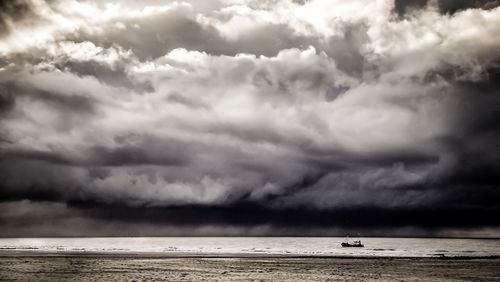 Scenic view of sea against cloudy sky