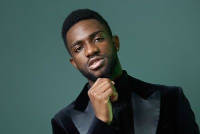 Portrait of young man against gray background
