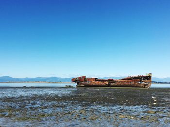 Scenic view of sea against clear blue sky