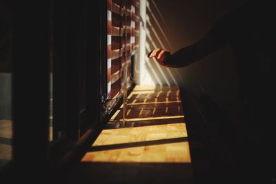 Human hand over window sill