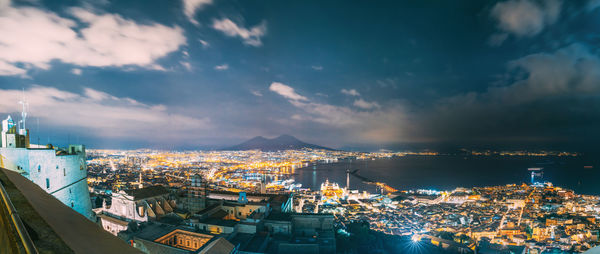 High angle view of illuminated cityscape against sky at night