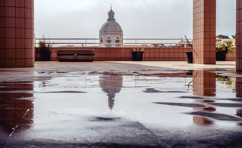 Reflection of building in puddle