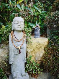 Statue against stone wall