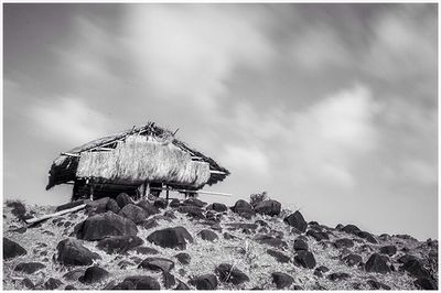 Abandoned building against cloudy sky