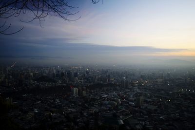 High angle view of city buildings against sky during sunset