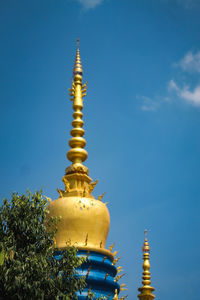 Low angle view of traditional building against blue sky