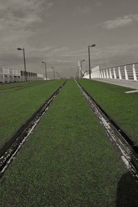 Footpath on field against sky