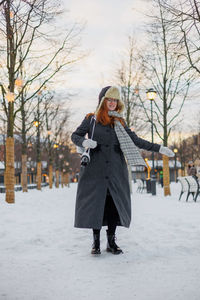 Full length of woman standing in snow