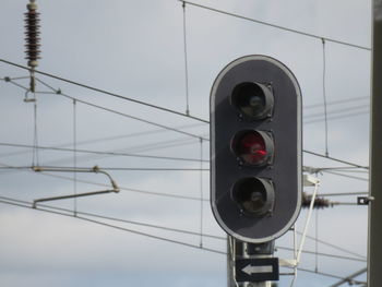 Close-up of stoplight against sky