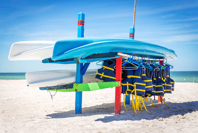 Lifeguard hut on beach against blue sky