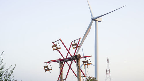 Low angle view of wind turbine against clear sky