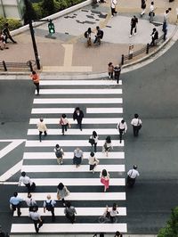 High angle view of people walking on road