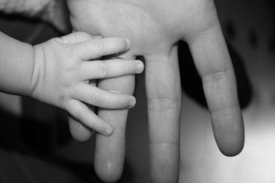 Close-up of hands holding baby hand