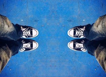 Low section of man standing on tiled floor