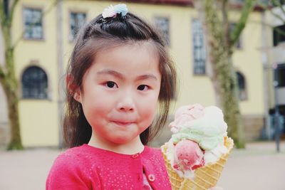 Portrait of cute girl with pink face outdoors