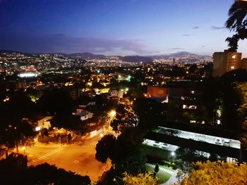 High angle view of illuminated buildings against sky at night