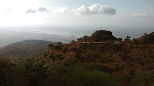 Scenic view of sea against cloudy sky