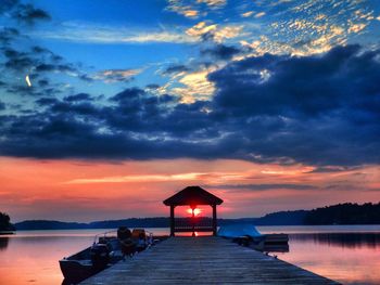 Pier on sea at sunset