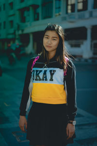 Portrait of a smiling young woman in city