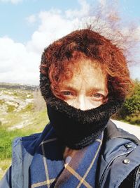 Portrait of woman in park against sky during winter