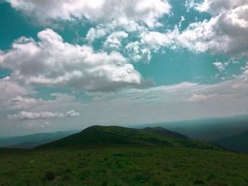 Scenic view of green landscape against sky