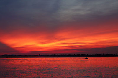 Scenic view of dramatic sky over sea during sunset