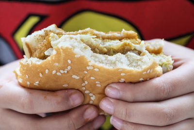 Close-up of hand holding burger