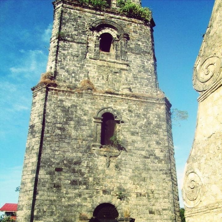 architecture, built structure, building exterior, low angle view, history, old, religion, church, the past, sky, place of worship, blue, tower, stone wall, spirituality, arch, old ruin, cross, ancient