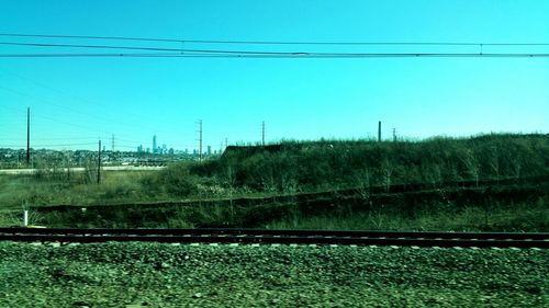 View of landscape against clear blue sky