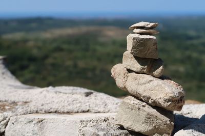 Stack of rocks on land against sky