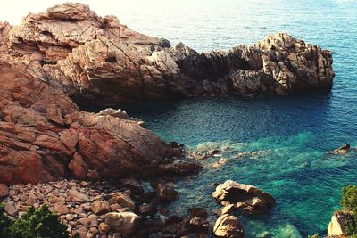 High angle view of rocks on sea shore