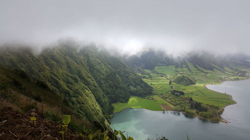 High angle view of green landscape against sky