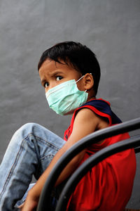 Portrait of a boy sitting outdoors