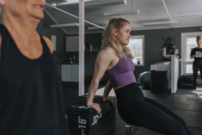 Smiling young woman training in gym