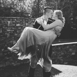 Rear view of couple on woman outdoors