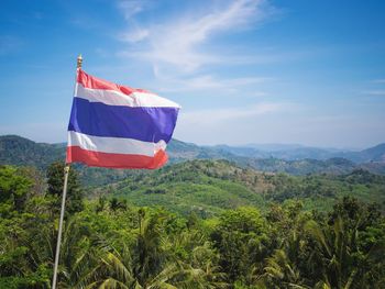 Flag of thailand with view on phuket