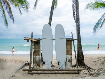 Lifeguard hut on beach against sky
