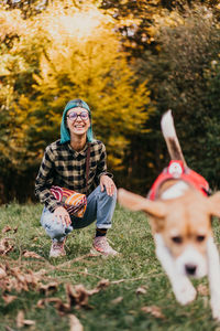 Portrait of woman playing with ball on field