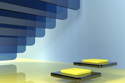 Close-up of yellow telephone on table against wall