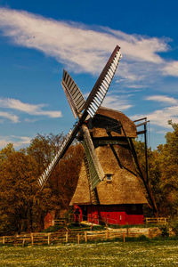 Low angle view of windmill against sky during sunset